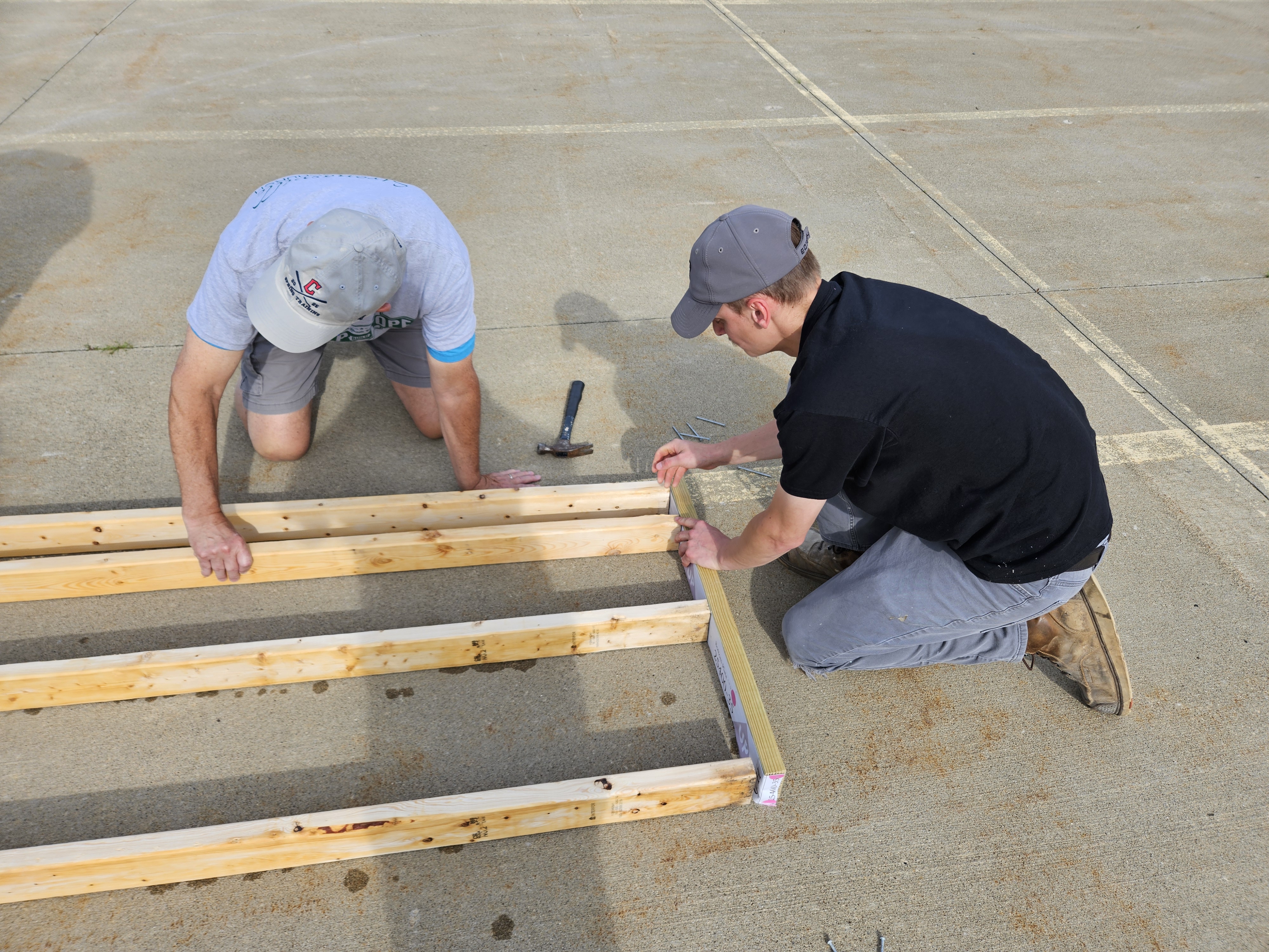 Volunteers build a frame.