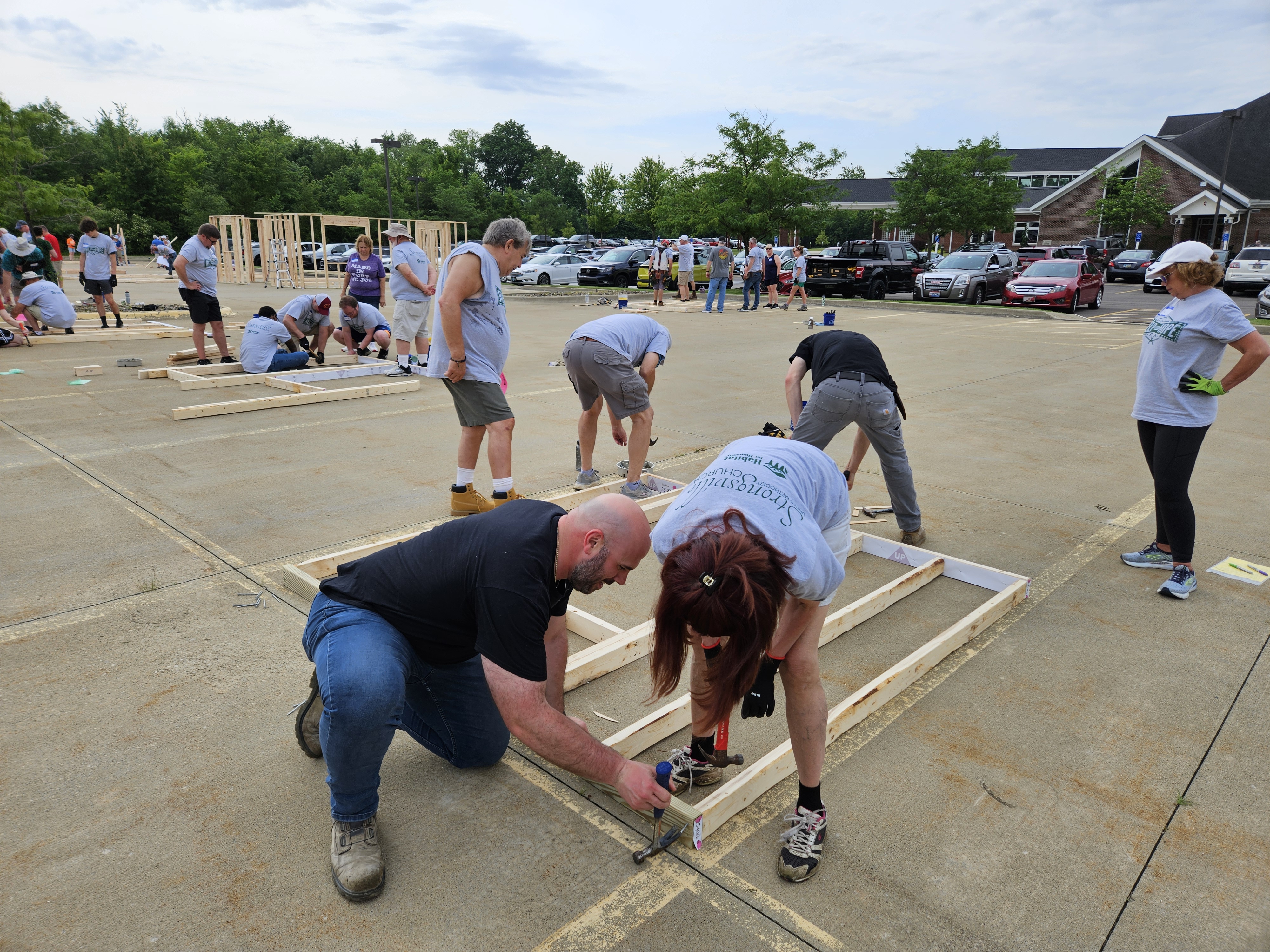Volunteers build a frame.