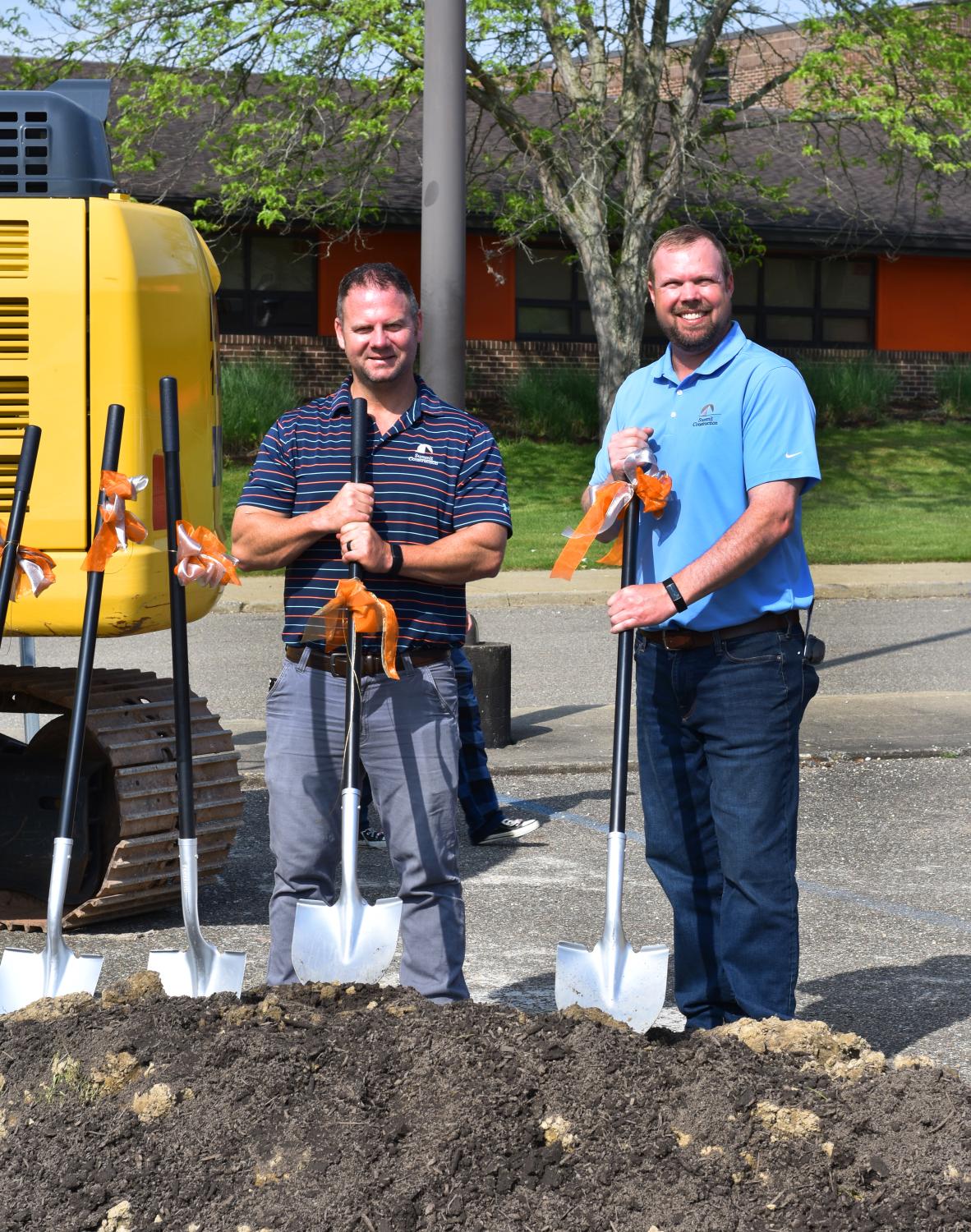 Two Summit team members posing for groundbreaking photos 