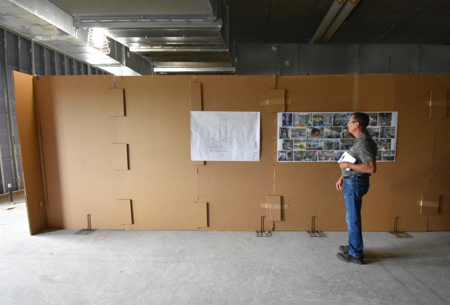 Mike Spurr standing by cardboard mock-up and images 