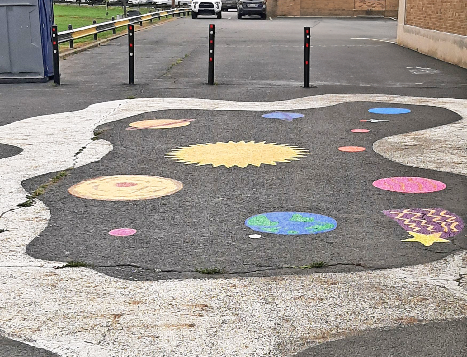 Painted mural of the galaxy on the ground.