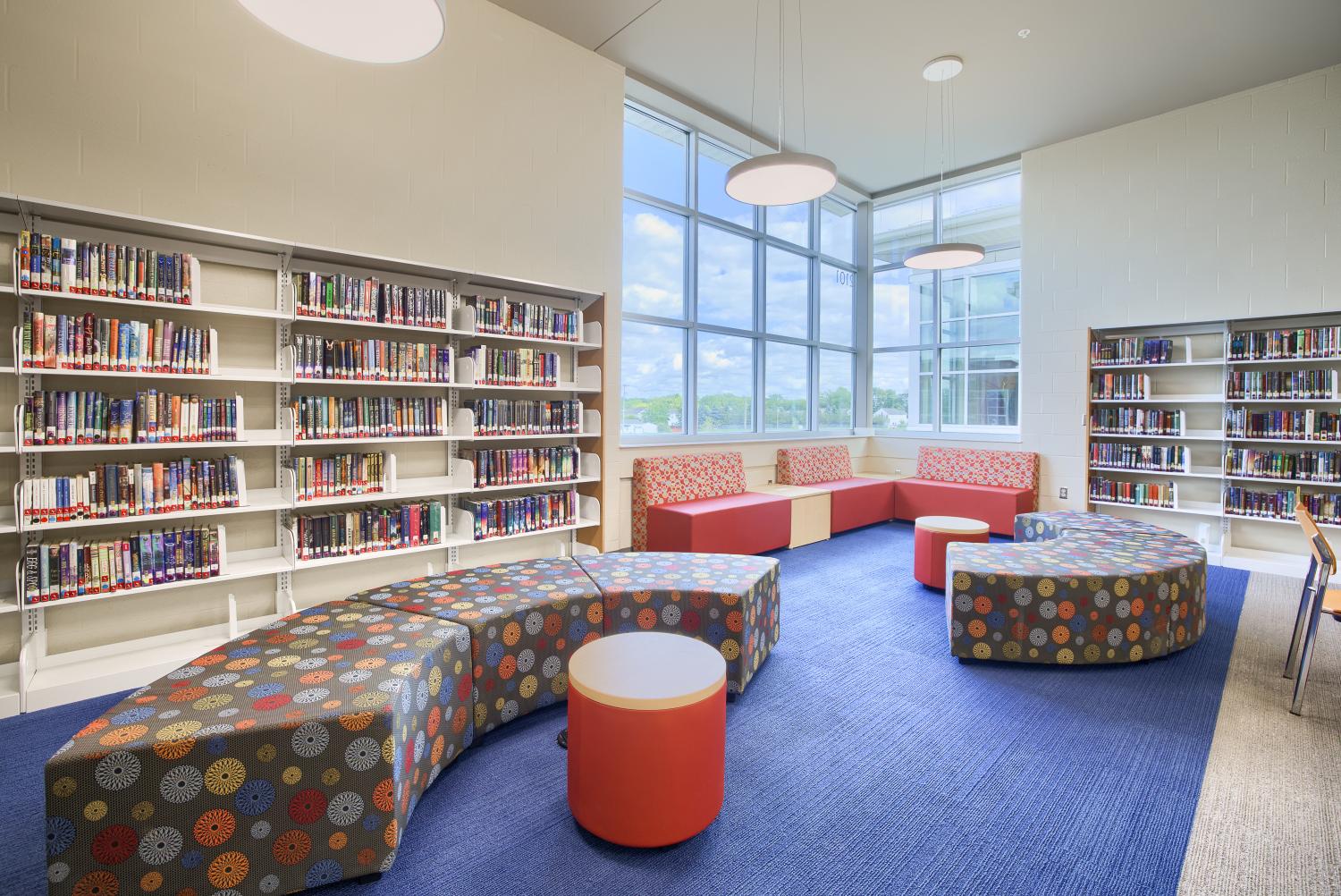 Middle school library with books, seating and a window 