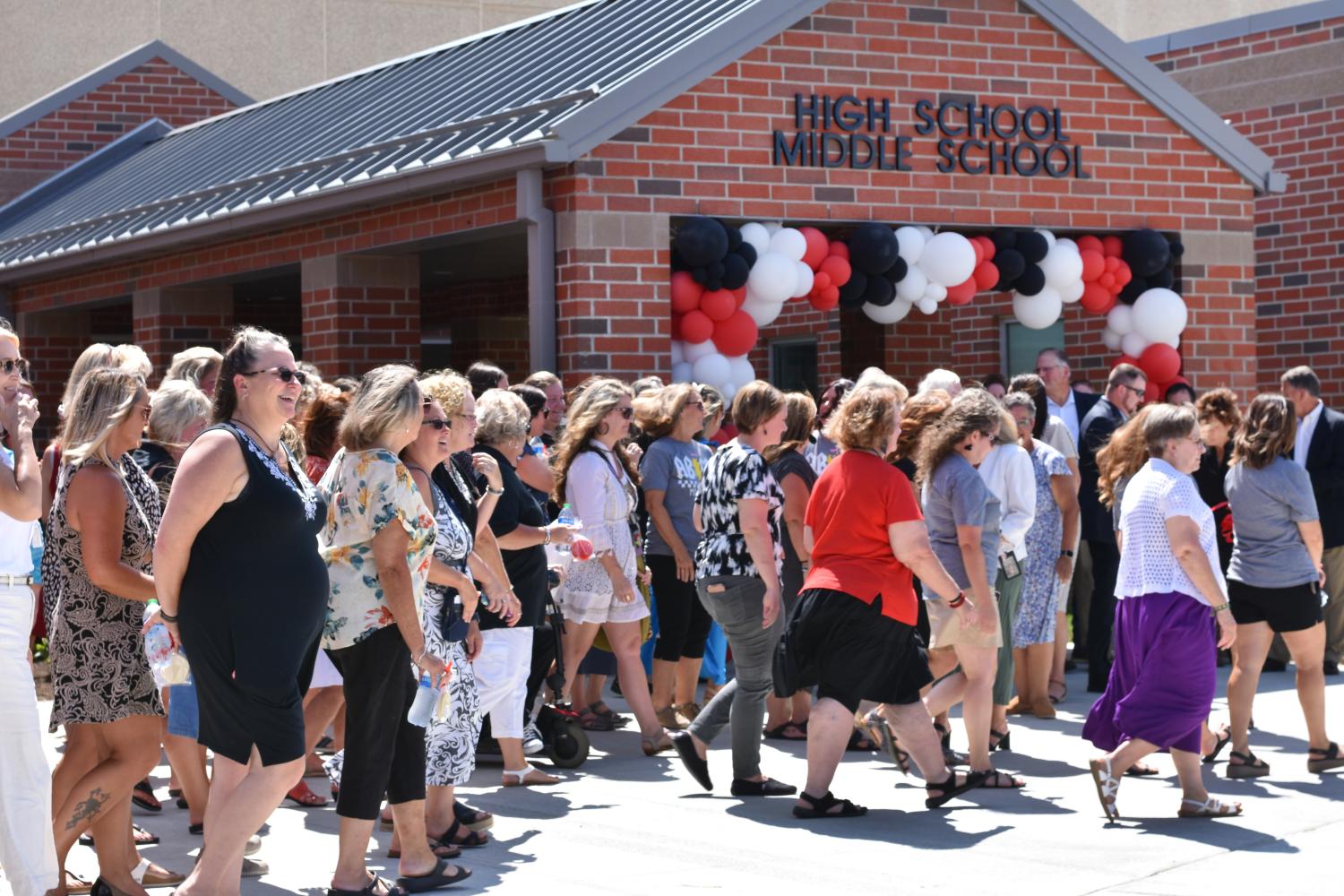 Teachers walk into new PK-12 school 