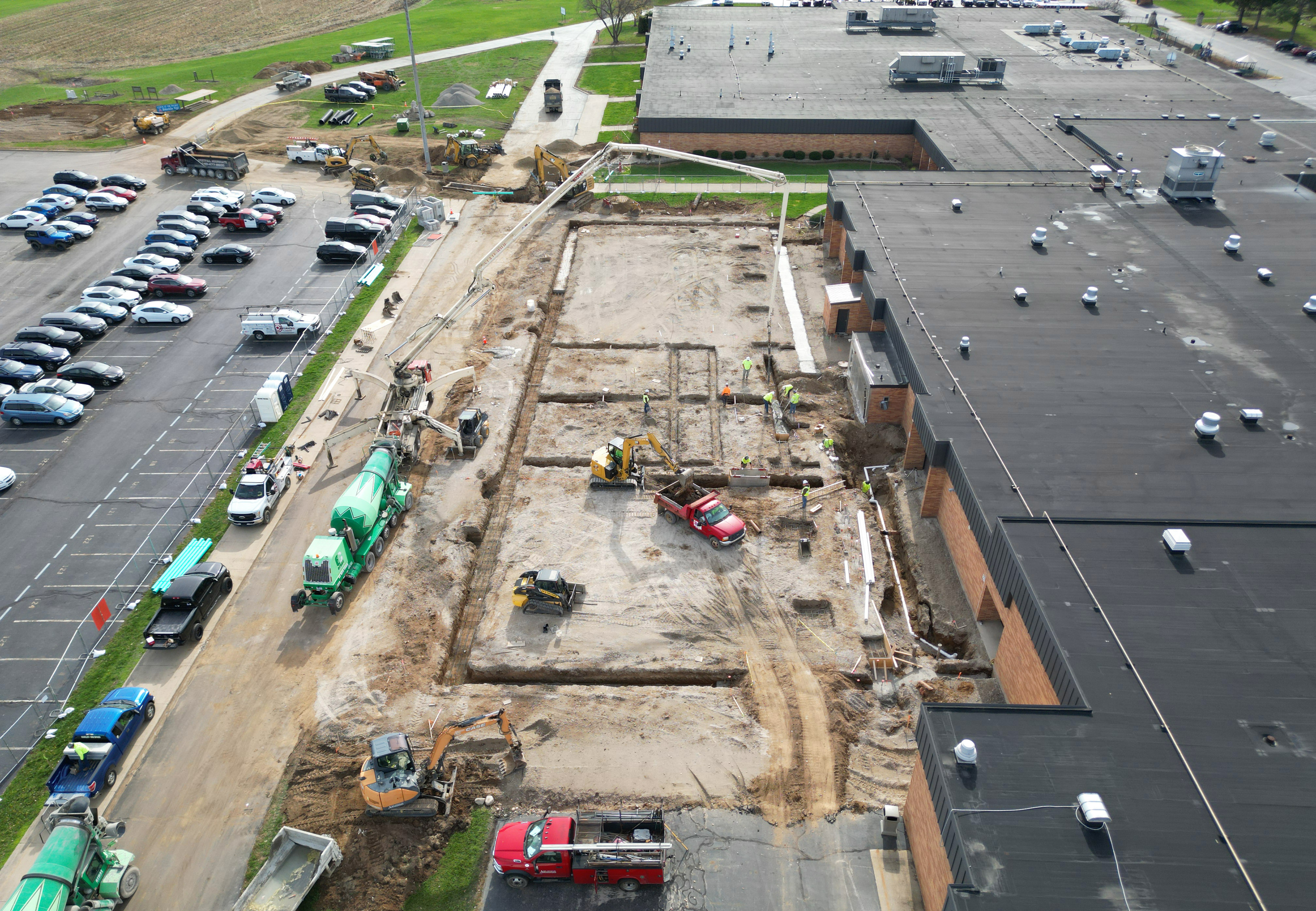 Construction worker walks toward building.