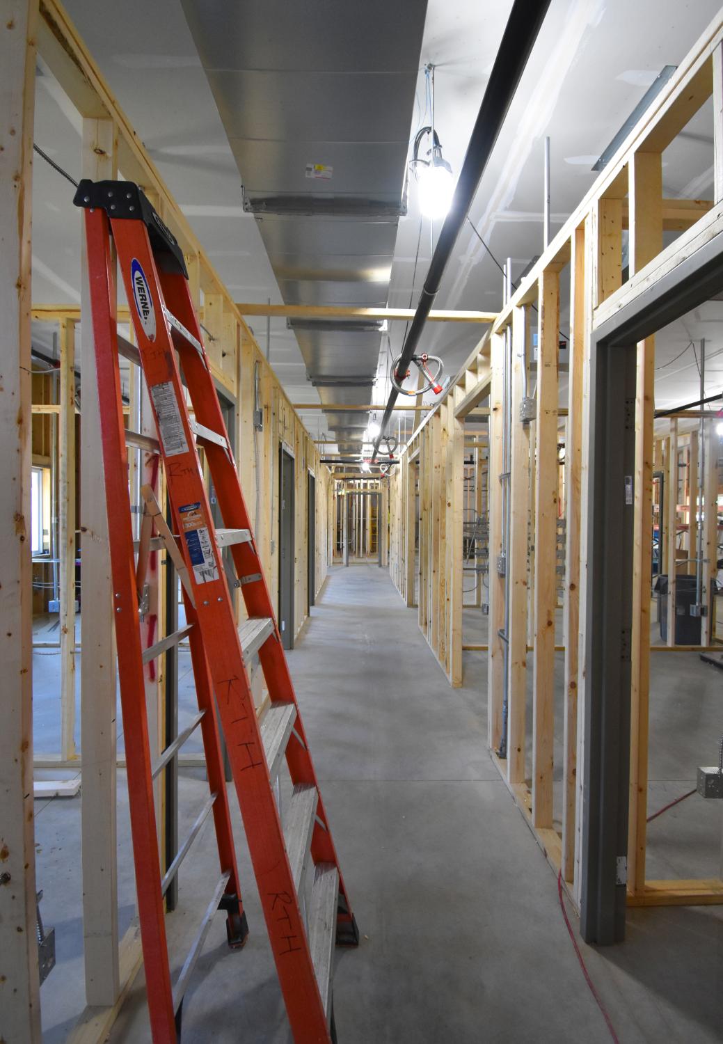 A ladder leans against a wall inside.